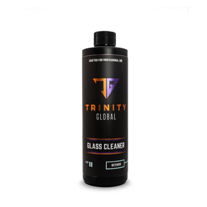 A black spray bottle labeled 'Trinity Global Glass Cleaner' with orange and white text indicating the product is for professional use and designed for glass.