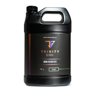 A black spray bottle labeled 'Trinity Global Iron Remover' with orange and purple text indicating the product is for professional use and made in the USA.